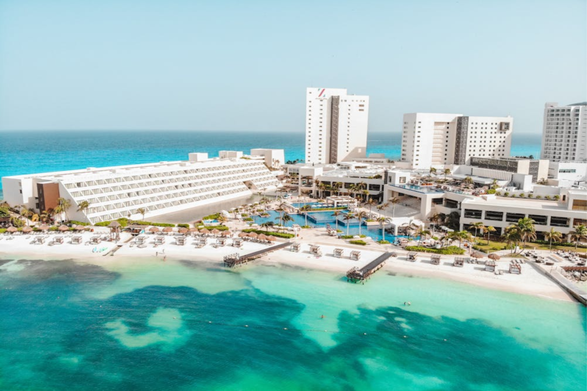 Beachfront all-inclusive resort in Mexico with pools, lounge areas, and turquoise water.